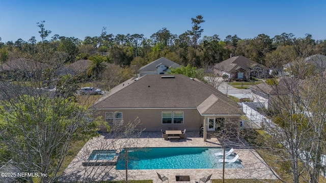 view of pool featuring a patio area and a pool with connected hot tub