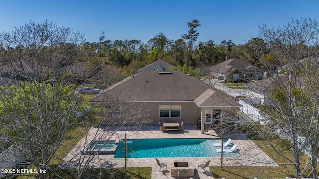 view of pool featuring a patio and a pool with connected hot tub