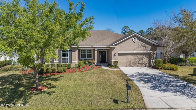 view of front of home with stucco siding, a front yard, a garage, and driveway