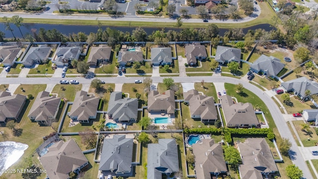 drone / aerial view with a residential view and a water view