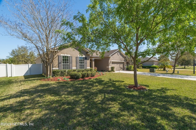 ranch-style home with stucco siding, fence, concrete driveway, a front yard, and a garage