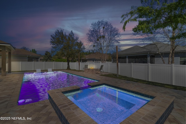 view of pool featuring an outdoor fire pit, an in ground hot tub, a fenced backyard, and a patio area