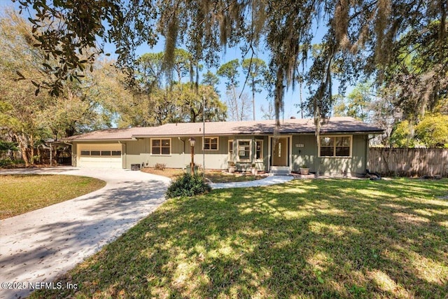 single story home featuring a garage, concrete driveway, a front lawn, and fence