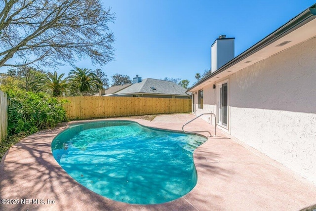 view of pool featuring a patio, a fenced backyard, and a fenced in pool