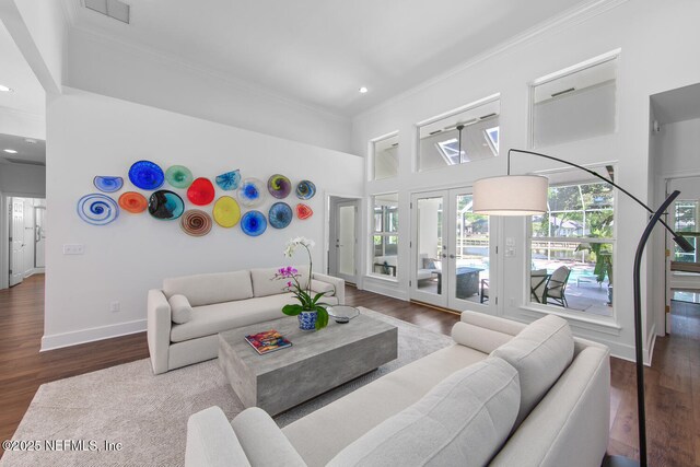 living room featuring crown molding, visible vents, recessed lighting, wood finished floors, and french doors