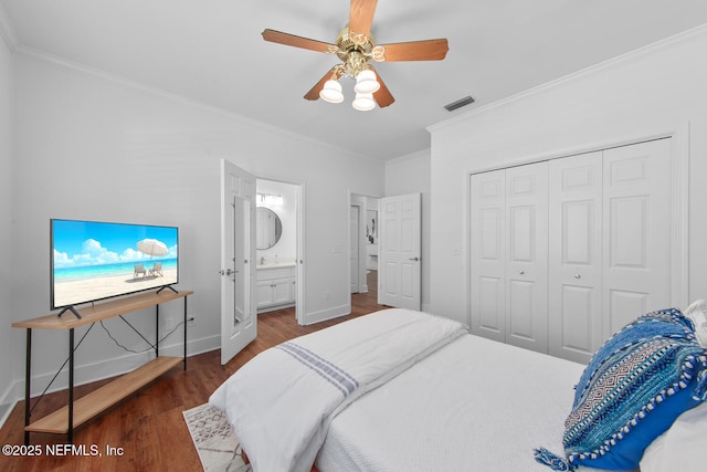 bedroom with visible vents, baseboards, a closet, ornamental molding, and wood finished floors