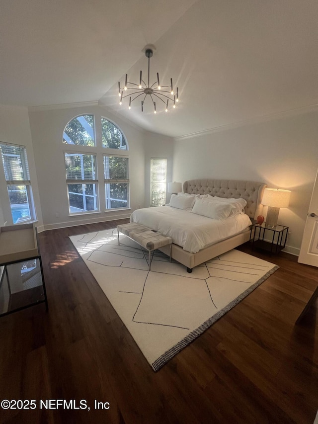 bedroom with lofted ceiling, a chandelier, wood finished floors, and baseboards
