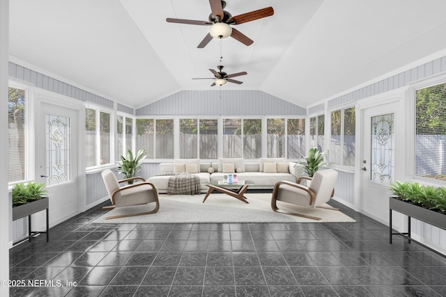 unfurnished sunroom with plenty of natural light, a ceiling fan, and vaulted ceiling