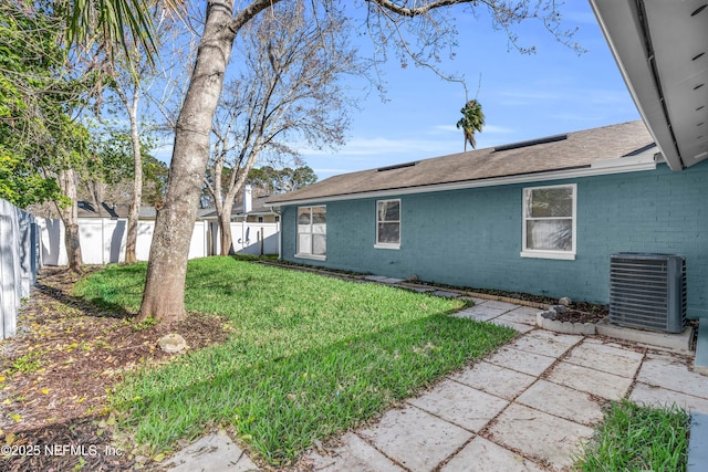 view of yard featuring central air condition unit and a fenced backyard