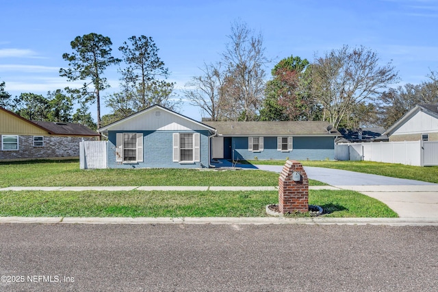 single story home with a front yard, fence, and driveway