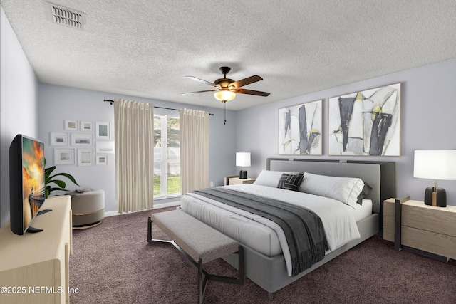 bedroom featuring a ceiling fan, visible vents, dark colored carpet, and a textured ceiling