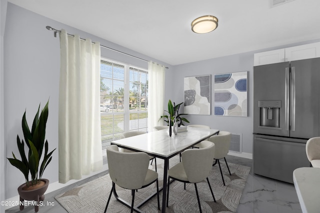 dining area with visible vents, marble finish floor, and baseboards