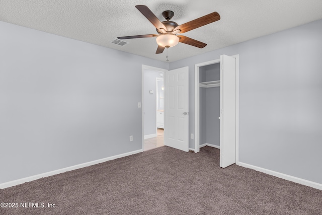 unfurnished bedroom featuring baseboards, carpet, visible vents, and a textured ceiling