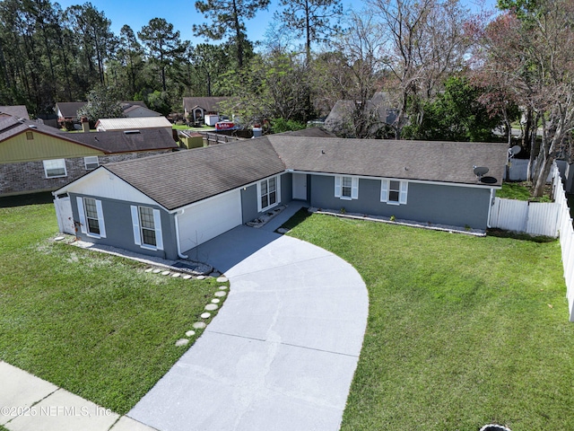 ranch-style home with driveway, fence, a front yard, a shingled roof, and a garage