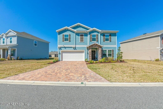 view of front facade featuring a front lawn, an attached garage, stone siding, and driveway