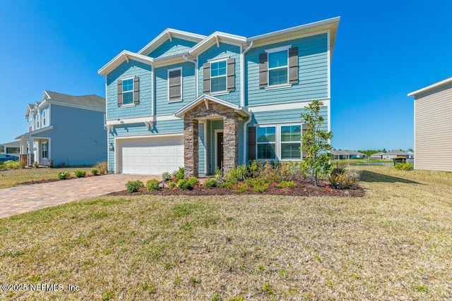 view of front of property featuring a garage, stone siding, a front lawn, and decorative driveway