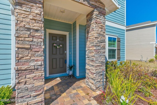 view of exterior entry with stone siding