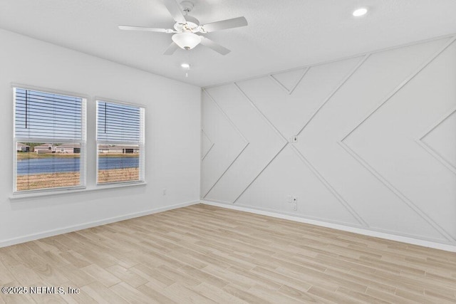 unfurnished room featuring a ceiling fan, recessed lighting, light wood-style floors, and baseboards