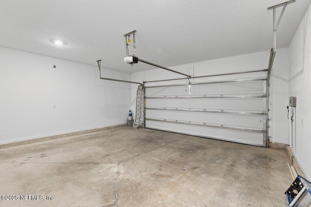 garage featuring a garage door opener and baseboards