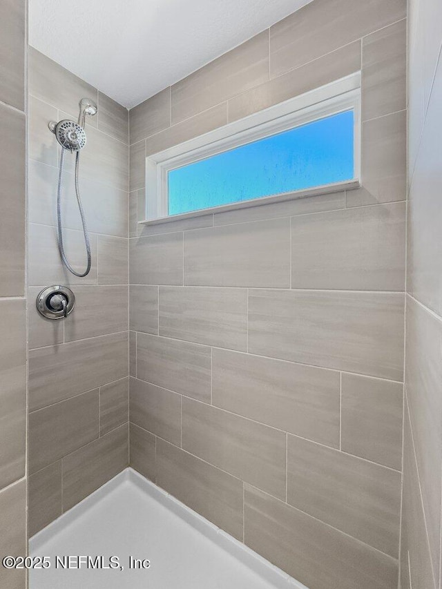 bathroom with a tile shower