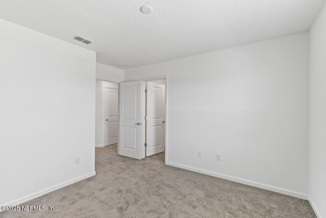 unfurnished bedroom featuring carpet flooring, baseboards, and visible vents