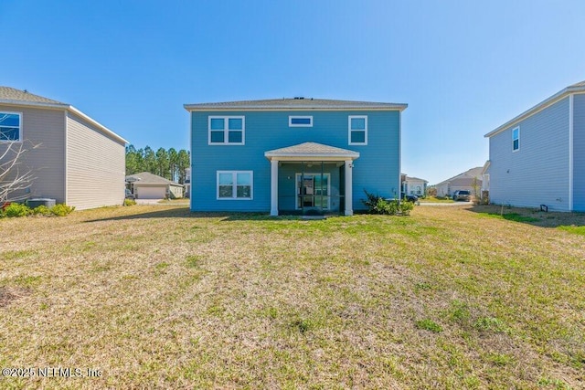 rear view of house with a yard