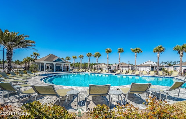 pool featuring a patio and fence