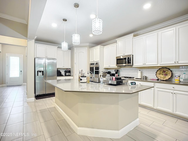 kitchen featuring decorative backsplash, a large island, white cabinets, and stainless steel appliances