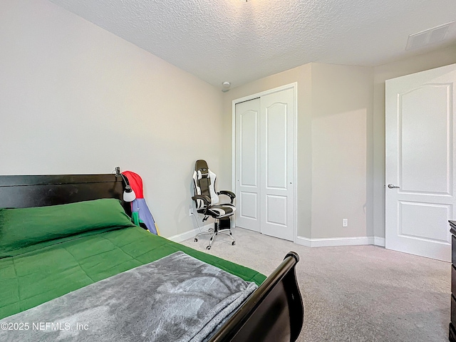 bedroom with carpet flooring, baseboards, a closet, and a textured ceiling