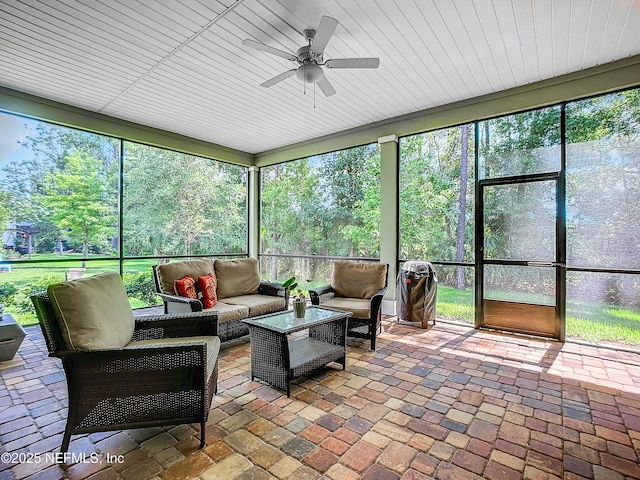 sunroom with a ceiling fan