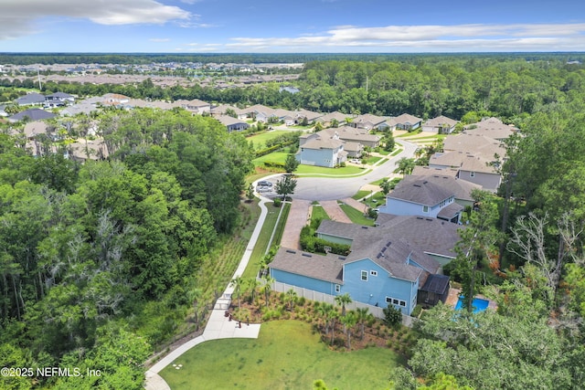 aerial view featuring a view of trees and a residential view