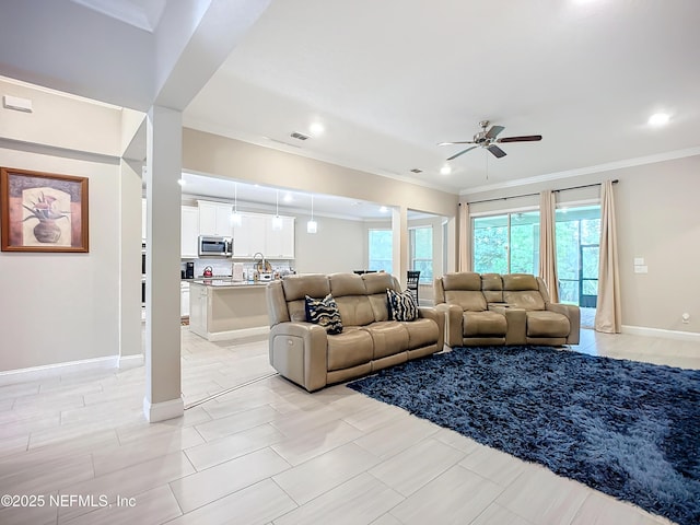 living room featuring visible vents, baseboards, recessed lighting, ceiling fan, and ornamental molding