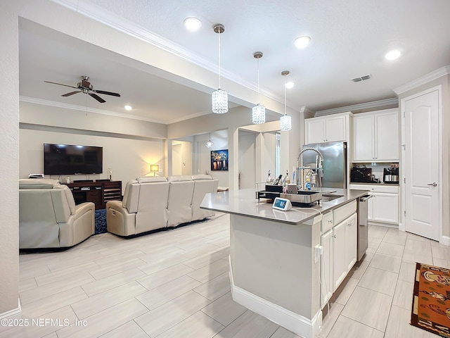 kitchen featuring open floor plan, visible vents, white cabinets, and stainless steel appliances