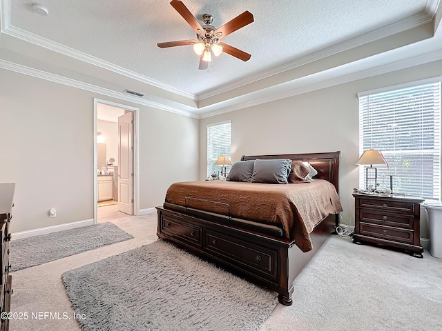 carpeted bedroom featuring baseboards, visible vents, ornamental molding, a textured ceiling, and connected bathroom