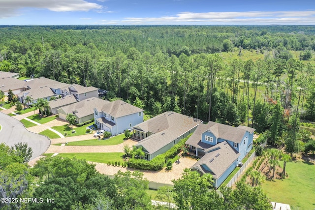 birds eye view of property with a forest view and a residential view