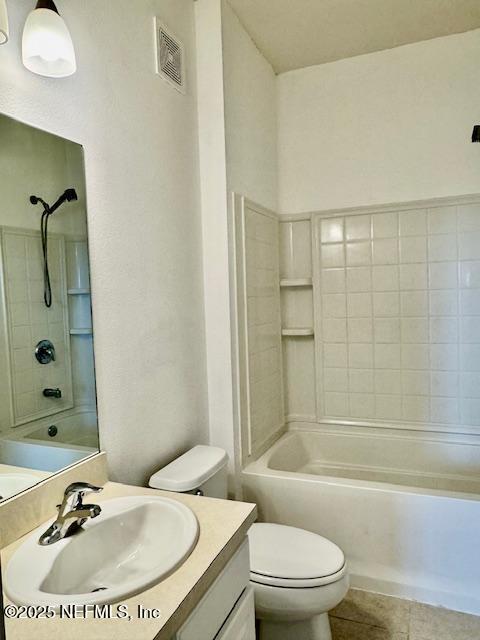 full bathroom featuring vanity, visible vents,  shower combination, tile patterned flooring, and toilet