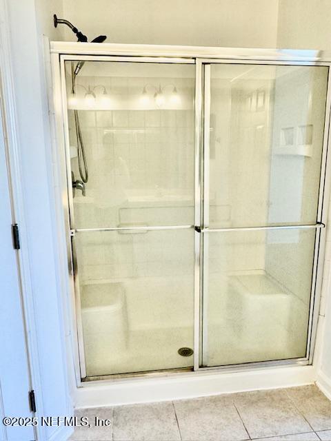 bathroom featuring tile patterned floors and a stall shower