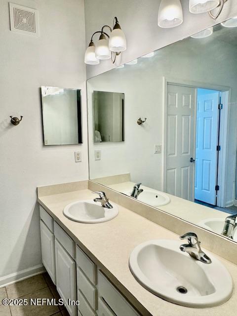 full bath with tile patterned floors, visible vents, and a sink