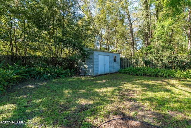 view of yard featuring an outbuilding and a storage shed