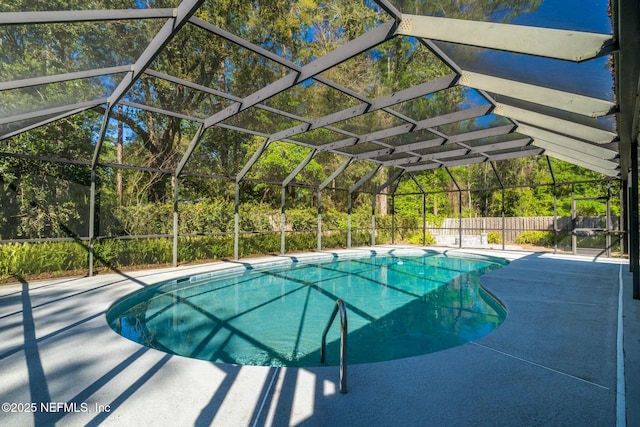 view of pool featuring a lanai, fence, a fenced in pool, and a patio area