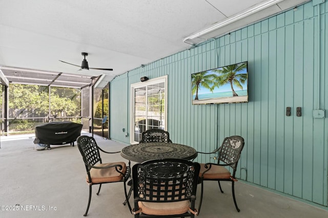 view of patio with a lanai and a ceiling fan