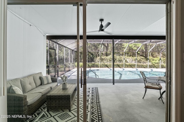 sunroom featuring a pool and ceiling fan