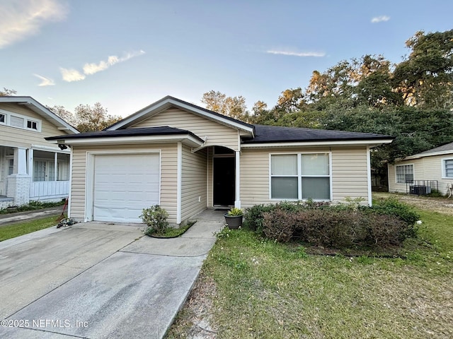 view of front of property with cooling unit, concrete driveway, and a garage