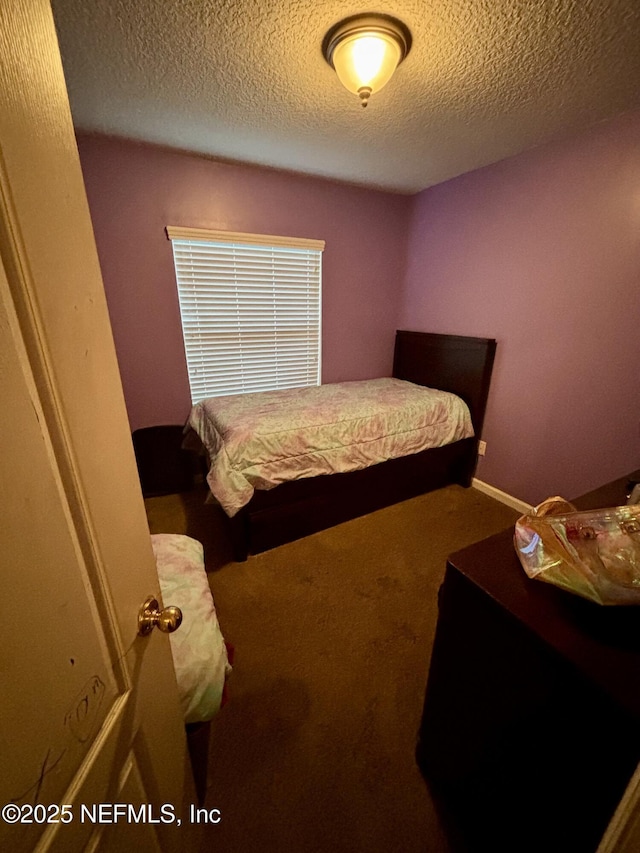 carpeted bedroom with a textured ceiling