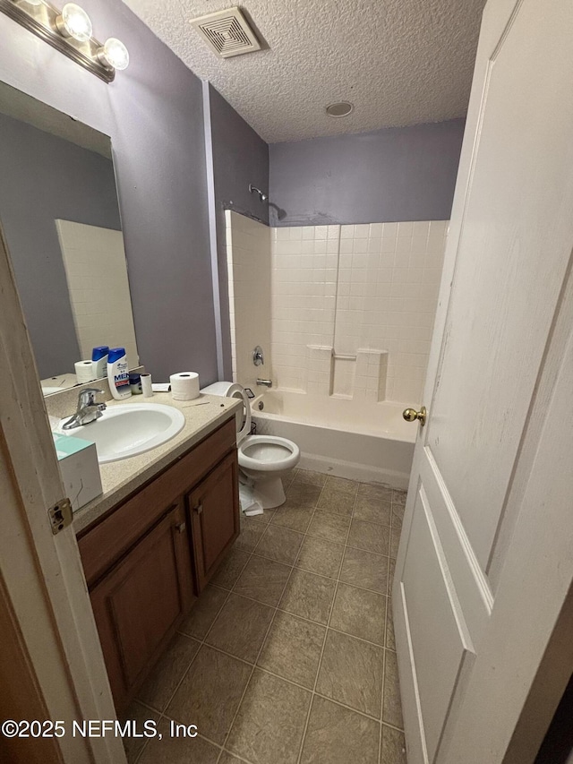 bathroom with visible vents, toilet, a textured ceiling, shower / washtub combination, and vanity