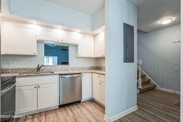 kitchen with dishwasher, electric panel, range with electric stovetop, light wood-style floors, and a sink