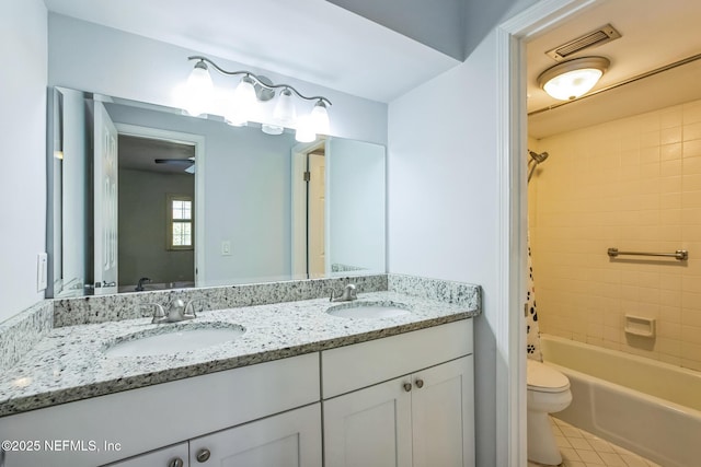 full bath featuring double vanity, toilet, visible vents, and a sink