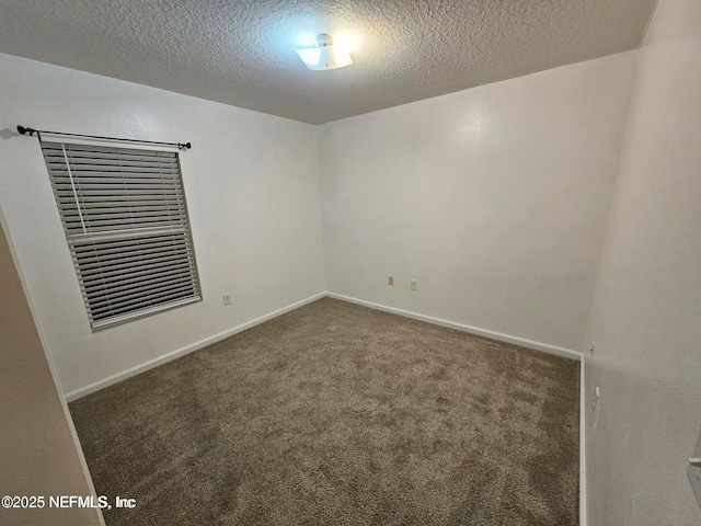 unfurnished room with baseboards, carpet, and a textured ceiling