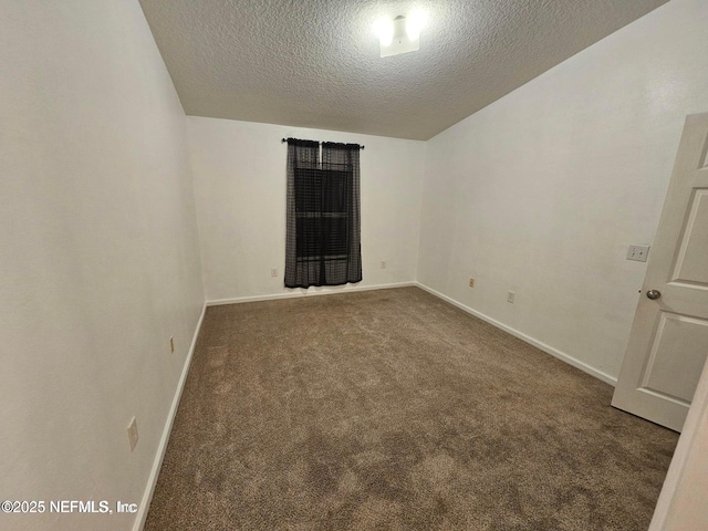 unfurnished room with baseboards, carpet, and a textured ceiling