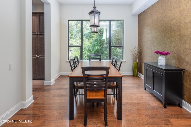 dining space featuring baseboards and wood finished floors